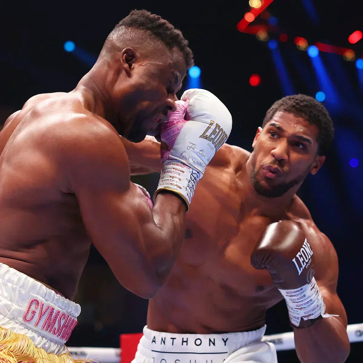 alt="Ngannou and Joshua in the ring wearing Leone Sport boxing gloves